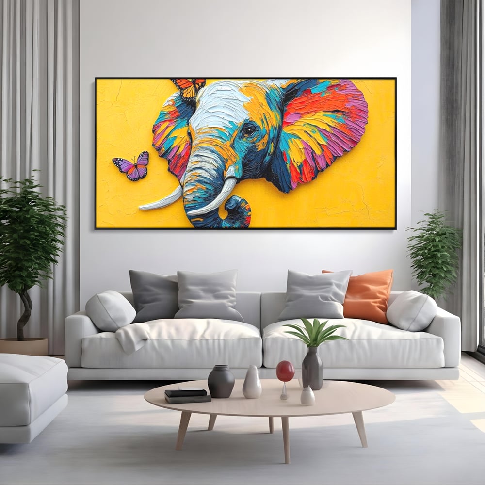 Tablou canvas cu tablou canvas cu elefant colorat si fluturi, in rama de aluminiu negru, pe perete intr-un living